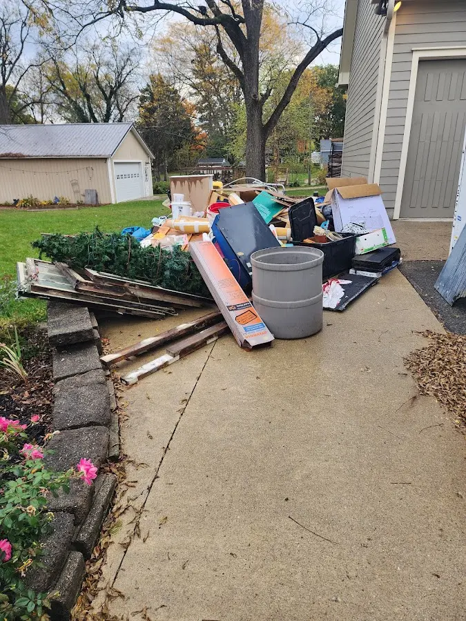 Dumpster being loaded with debris for 30 Yard Dumpster Rental in Mankato